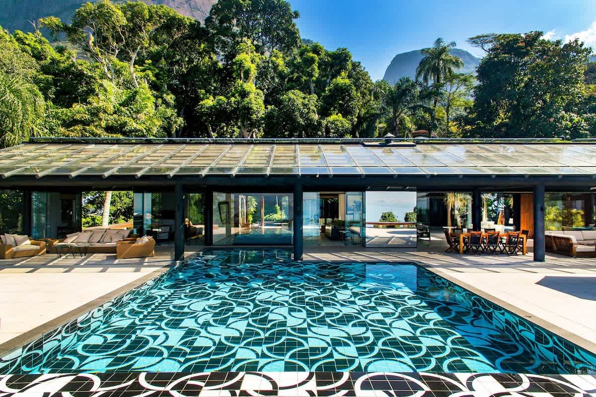 The mosaic infinity pool seen lengthways across the pool deck.