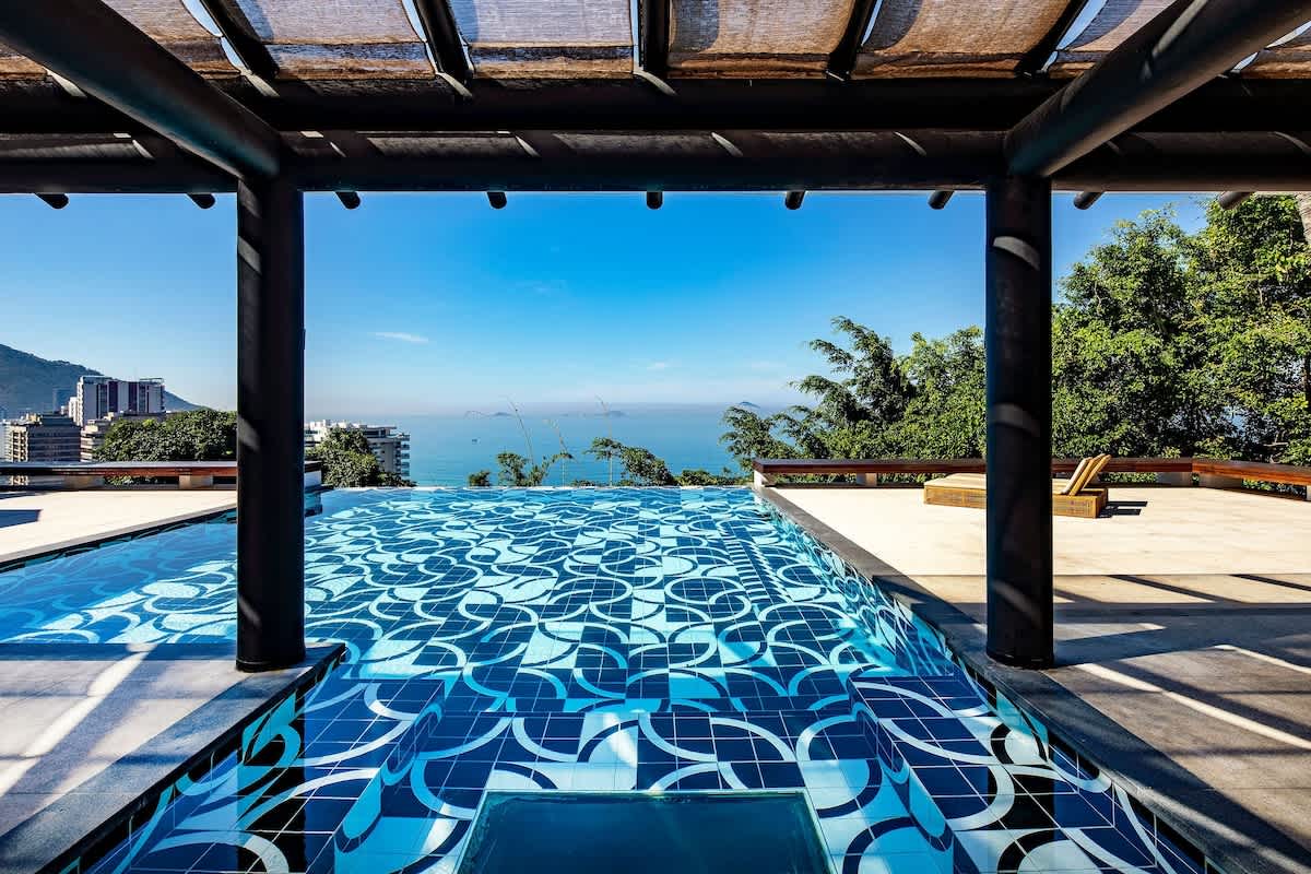 Pergola framing the Atlantic horizon over the infinity pool edge.