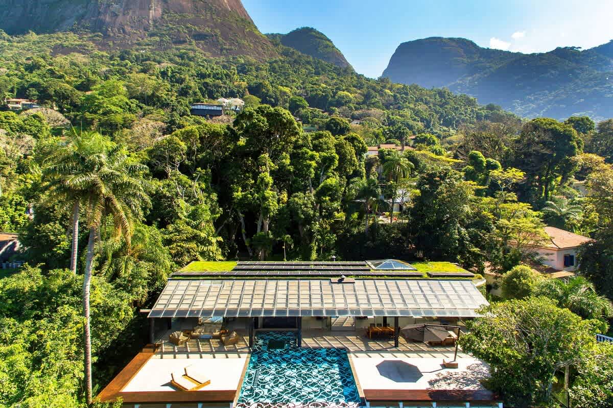 Aerial view of the villa platform set into the green hillside under Pedra da Gávea.